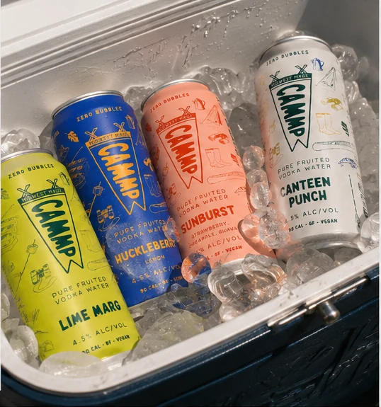 CAMMP vodka water variety cans chilled in a cooler