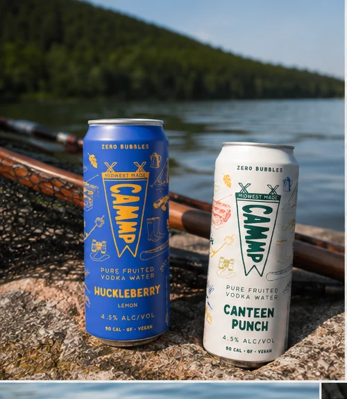 CAMMP Huckleberry and Canteen Punch cans by a lake