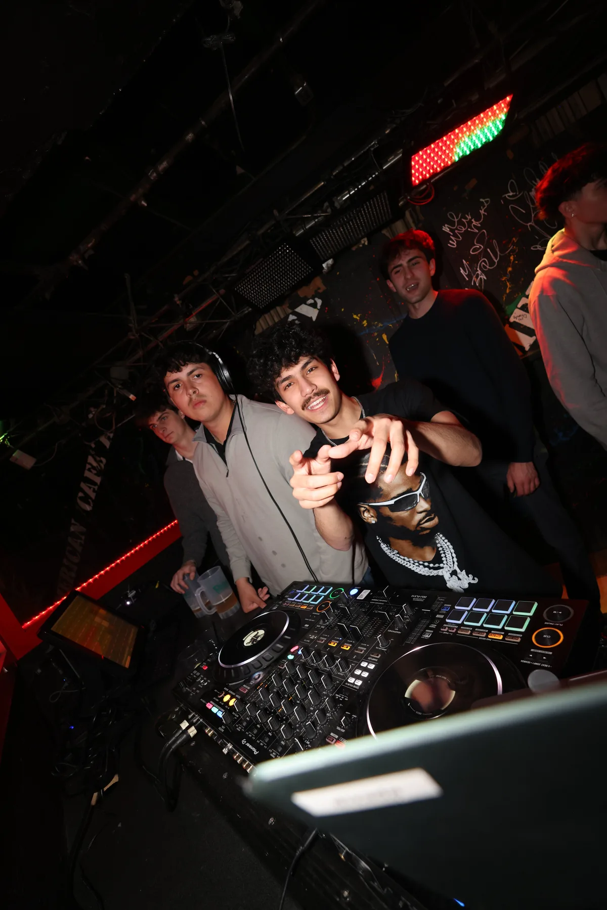 Group photo in front of the DJ booth
