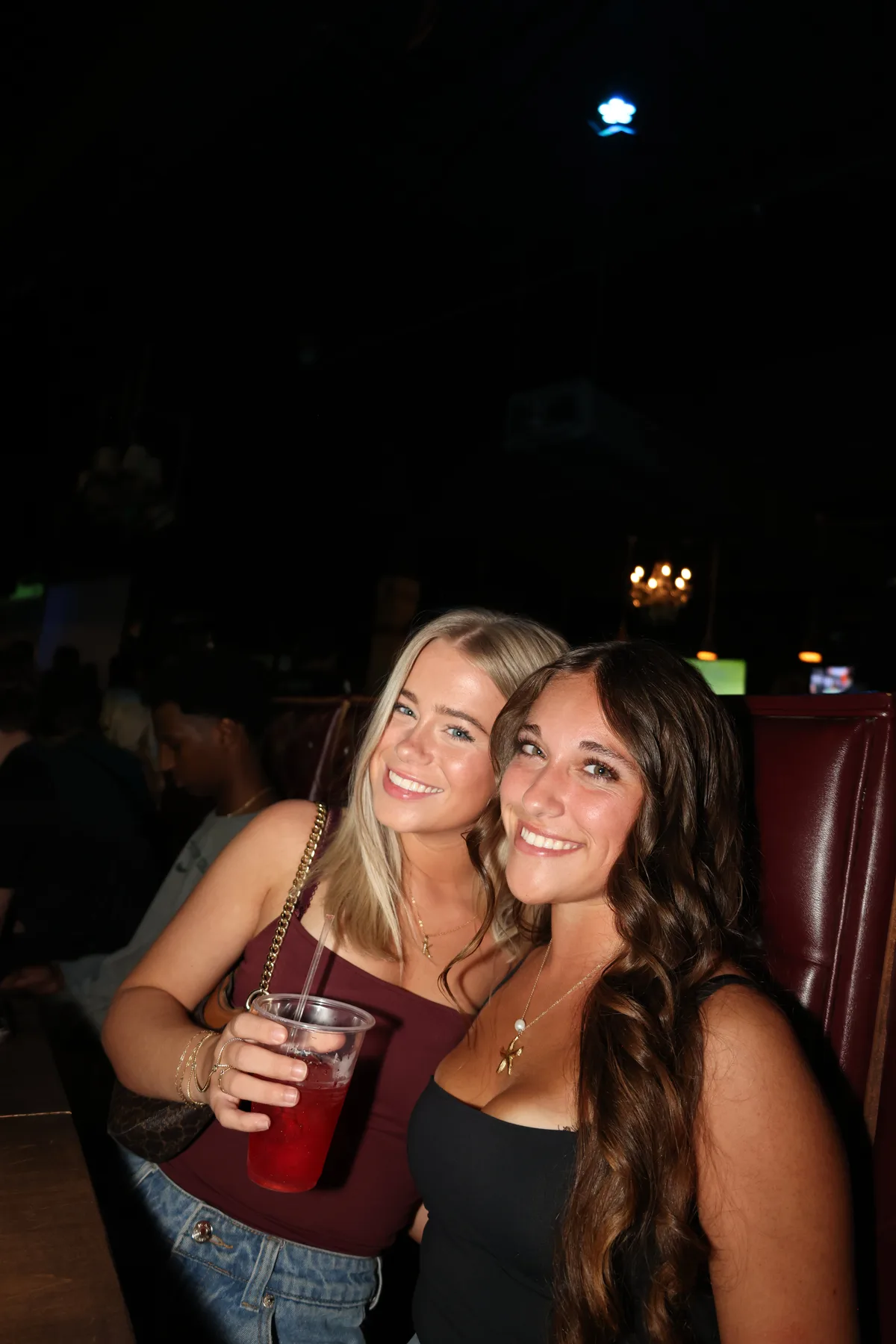 Friends posing in a bar booth
