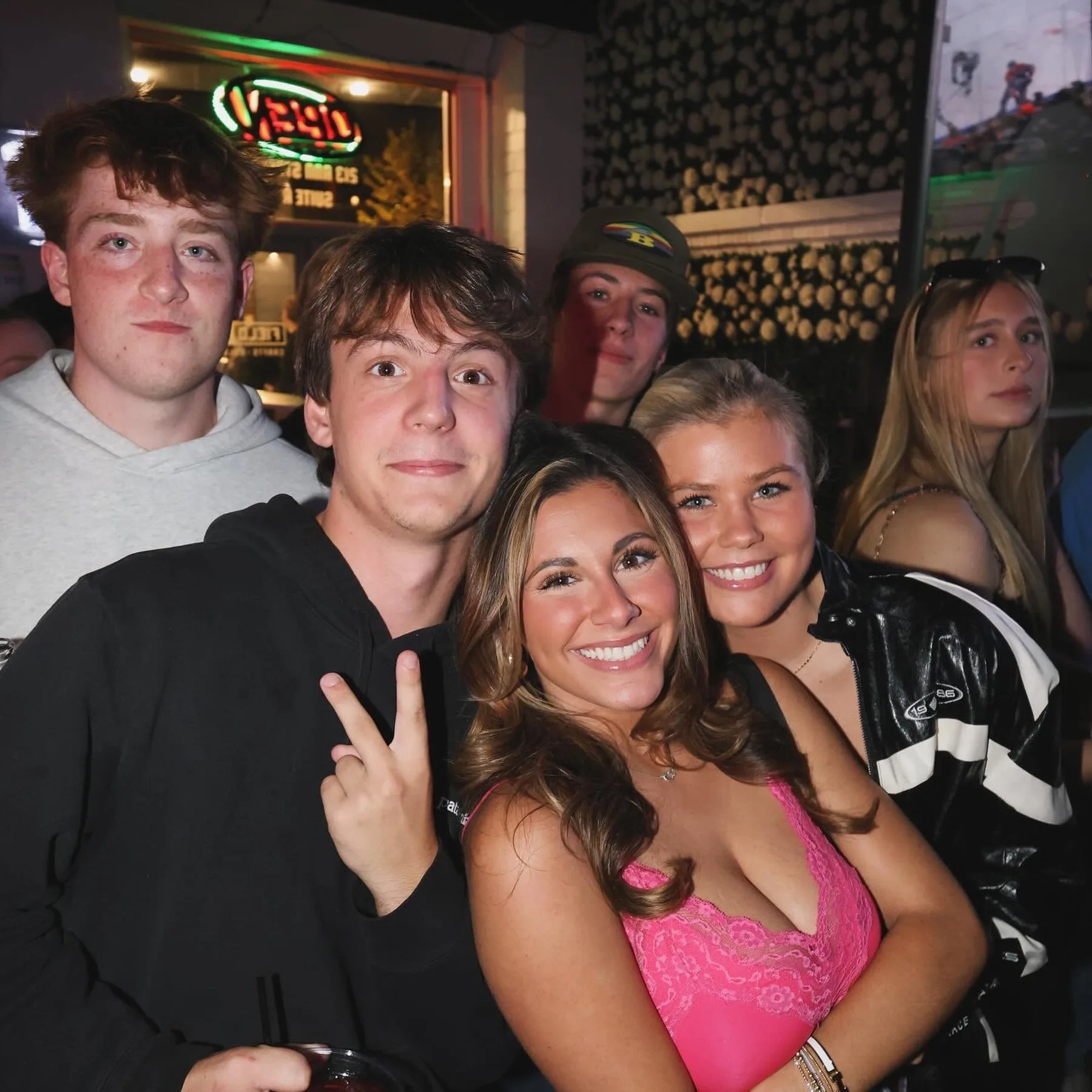 Two friends posing together at a college bar