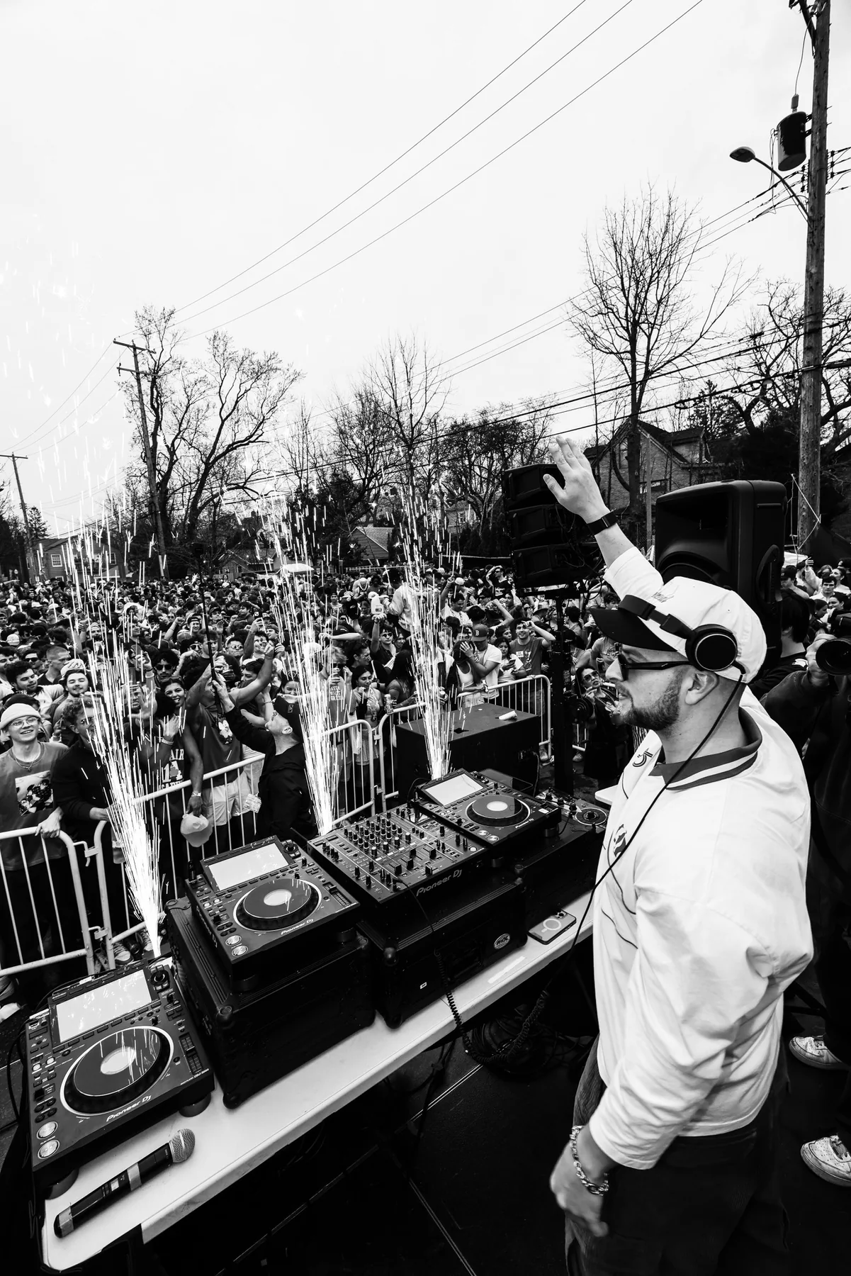 DJ performing to a large outdoor crowd